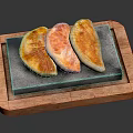 Three Crispy Golden Fried Dumplings on Stone Slab in Wooden Tray