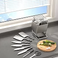 Stainless Steel Knife Block With Knives On Kitchen Countertop Near Cutting Board And Vegetables