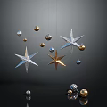 Multiple Hanging Shiny Star Ornaments With Gold And Silver Balls On Dark Background