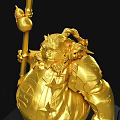 Golden Sculpture Carving Of Armored Figure Holding Staff On Black Cracked Base