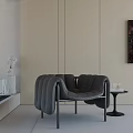 Modern Black Padded Leisure Chair With Side Table Glass Cups And Abstract Painting
