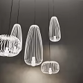 Modern White Wireframe Pendant Lights With Unique Shapes Hanging In Dark Setting