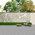 White Perforated Lattice Feature Wall with Greenery Outdoor Chair Coffee Table and Gray Tiled Floor