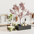 Stylish Clothes Display with Hangers Green Plants Green Chair and Black Table