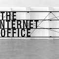 Modern Office Wall with THE INTERNET OFFICE Text and Geometric Lines Design