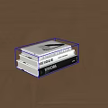 Stack of Books and Magazines on Geometric Pattern Wooden Floor