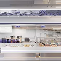 Modern Dessert Shop Interior With Open Display Counter Marble Countertop Blue Lines And Various Desserts