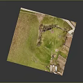 Aerial View of Ancient Ruins in Grassy Field With Surrounding Structures