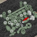 Green Pipe Fittings With Various Connectors Valves And Flanges On Dark Table
