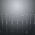 Various Modern Street Lamp Designs With Reflective Bases On Dark Background