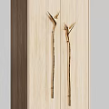 Elegant Golden Door Handles With Unique Curved Design On Light Wooden Cabinet Panels