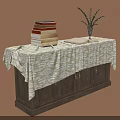 Dark Wooden Cabinet With Patterned Tablecloth Stack Of Books And Vase Plant