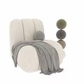 Cozy Cream Textured Single Sofa With Grey Blanket And Small Round Pillow