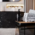 Modern Bathroom Accessories With Pump Bottles Stacked Towels And Marble Backdrop