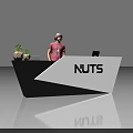 Exhibition Reception Desk with NUTS Logo Black White Design Small Plants and Staff Reception