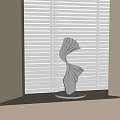 Abstract Silver Sculpture with Twisted Curved Design Metallic Finish on Windowsill Against White Blinds