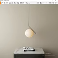 Elegant Spherical Pendant Light With Metal Frame Over Marble Countertop And Books
