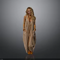 Blonde woman in light brown halter maxi dress with hands in pockets against gray background
