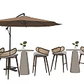 Outdoor Table And Chair Set With Woven Rattan Chairs Round Light Gray Table Brown Parasol And Small Green Plants