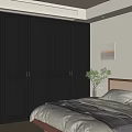 Dark Paneled Wardrobe with Brass Handles in Bedroom Featuring Potted Plant and Wall Art