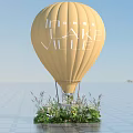 Floral Installation Featuring Yellow Hot Air Balloon with Flowers and Green Plants at Base