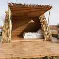 Garden Landscape Featuring Wooden Hut With Thatched Roof Wooden Deck And Outdoor Chairs