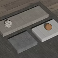 Gray Light Gray White Padded Cushions With Wooden Ball Knit Ornament On Wooden Floor Rug
