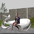Sculptural White Public Chair in Outdoor Space with Stone Wall Green Plants and Blue Sky