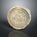 Detailed Circular Stone Sculpture Carved With Intricate Radiating Patterns And Textured Surface