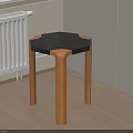 Modern Stool With Black Hexagonal Top And Wooden Legs In Room Corner On Wooden Floor