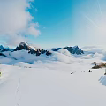 Breathtaking Snowy Mountain Landscape With Blue Sky Clouds Sunlight And Pine Trees