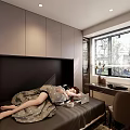 Woman Lying On Bed With Blanket Using Laptop In Bedroom By Window With Blinds