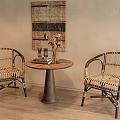 Wicker Lounge Chairs With Round Wooden Table In Cozy Indoor Space Featuring Textured Wall Art