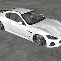 White Maserati Coupe With Sleek Exterior Design And Black Alloy Wheels In Modern Indoor Space