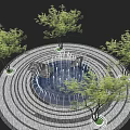Circular Water Fountain With Multiple Water Jets And Surrounding Trees On Stone Pavement