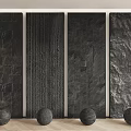 Different Textured Black Background Wall Panels With Decorative Spheres On Wooden Floor