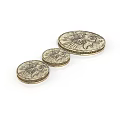 Intricate Sculpture Carving On Three Different Sized Coins With Detailed Engraved Patterns