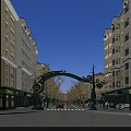 Ornate Green Archway Commercial Street With Yellow White Buildings Shops Pedestrians And Cars