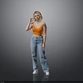 Blonde Woman In Orange Crop Top And Blue Wide Leg Jeans Standing Against Gray Background