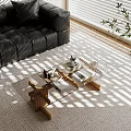 Glass Coffee Table With Wooden Legs On Rug Near Black Leather Sofa And Sunlight Patterns