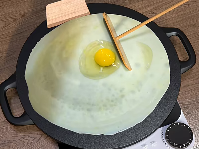 Non stick Frying Pan with Batter and Egg Yolk and Wooden Spatula on Stove Top 3d model