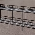 Black Metal Garden Bench With Decorative Design Along Grass Path And Green Landscape