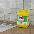 Liby Laundry Detergent Yellow Bottle on Kitchen Countertop with Tiled Wall