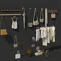 White Clothes with Beige Bags Hats and Umbrella Hanging on Wooden Rack and Hangers