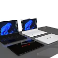 Three Modern Black And White Laptops With Blue Abstract Screens On Table