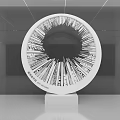 Circular Modern Art Installation With Radial Lines And Text On White Pedestal In Gray Space