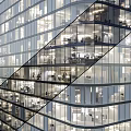 Modern High Rise Office Building With Glass Facade And Interior Workspace Lighting