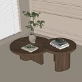 Round Wooden Tea Tables with Potted Plant Books and Decorative Moldings Near Window with Blinds