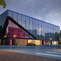 Modern Glass Building Exterior With Sloped Design Trees Street Lamps Vehicles And Brick Pavement