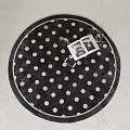 Round Black White Polka Dot Rug With Open Photo Album Smartphone And Small Plant